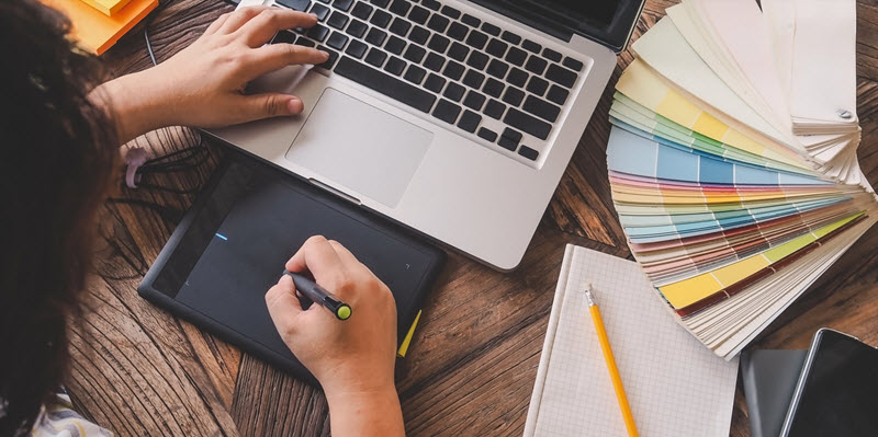 woman using a track pad to design a logo