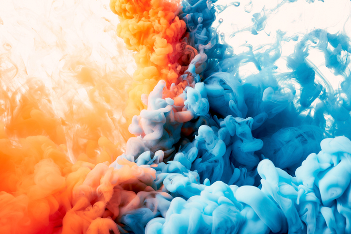 orange and blue ink colliding