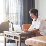 Women siting on couch researching impacts of Covid on small businesses